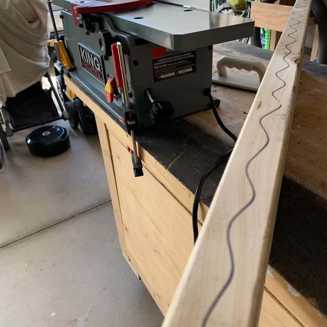 a jointer machine and a wooden workpiece on it