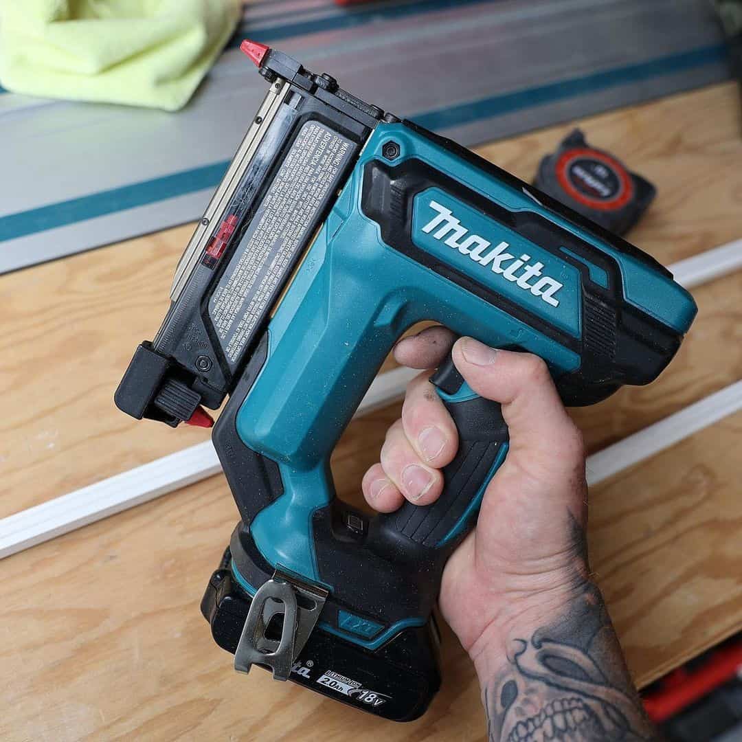 Blue pin nailer on the arms above the table