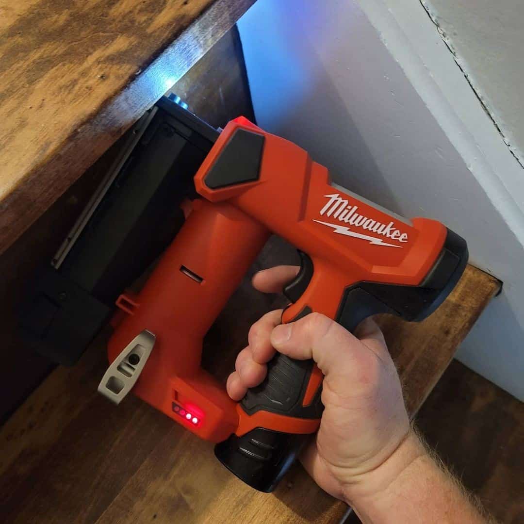 Red pin nailer with flash in hand