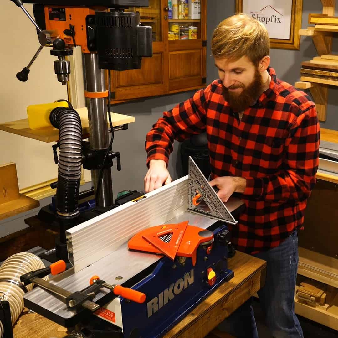 A man adjusts a jointer machine 