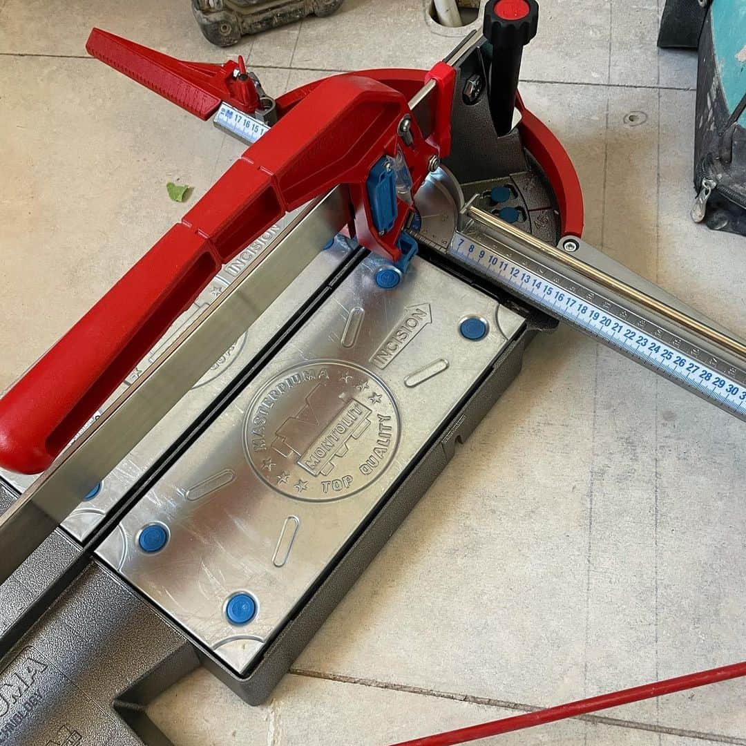 Red tile cutter on the floor