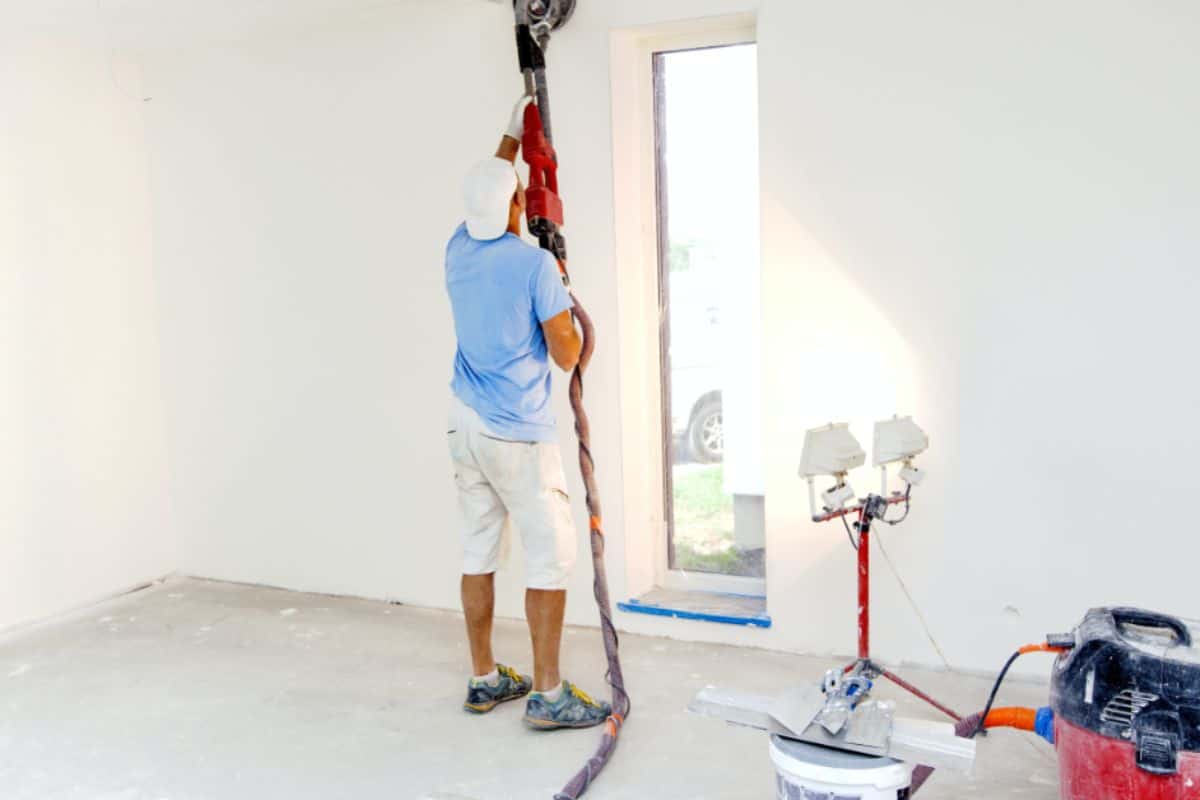 White room and an electric sander for drywall