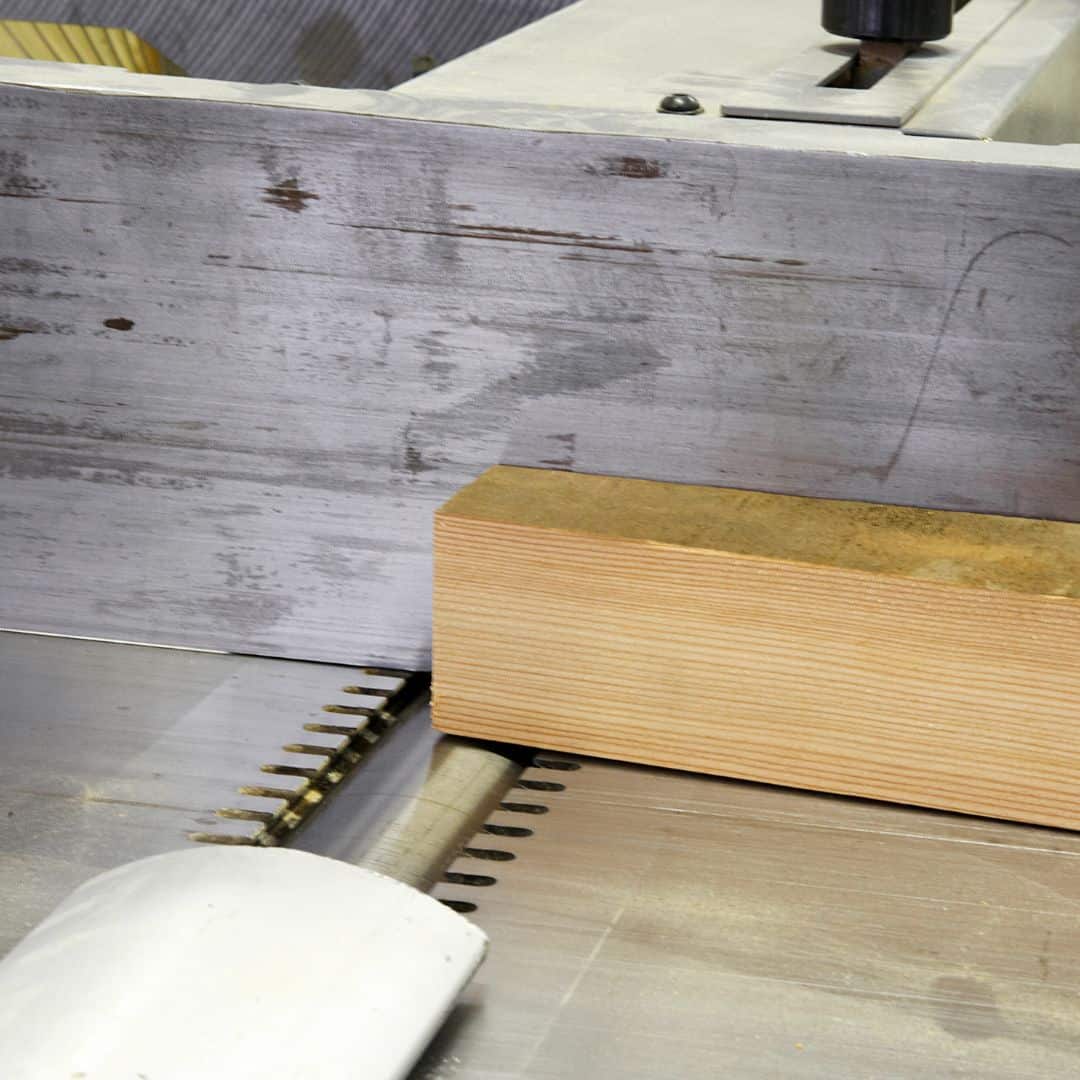 A wooden block on a jointer machine in close-up