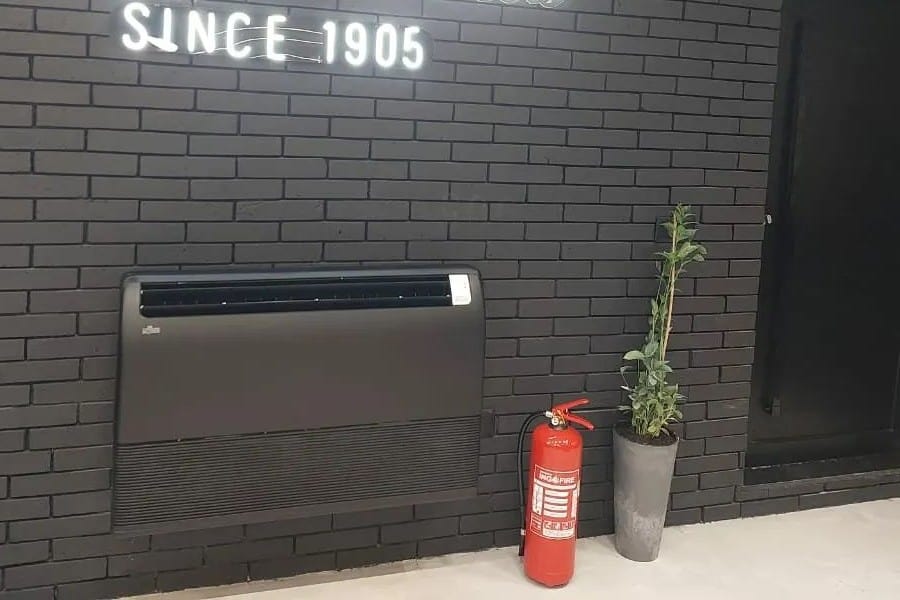 fire extinguisher in front of the wall