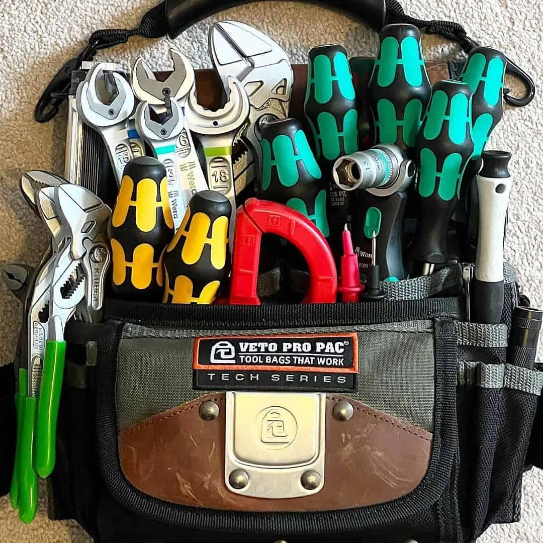 bag with hand tools hanging on the wall